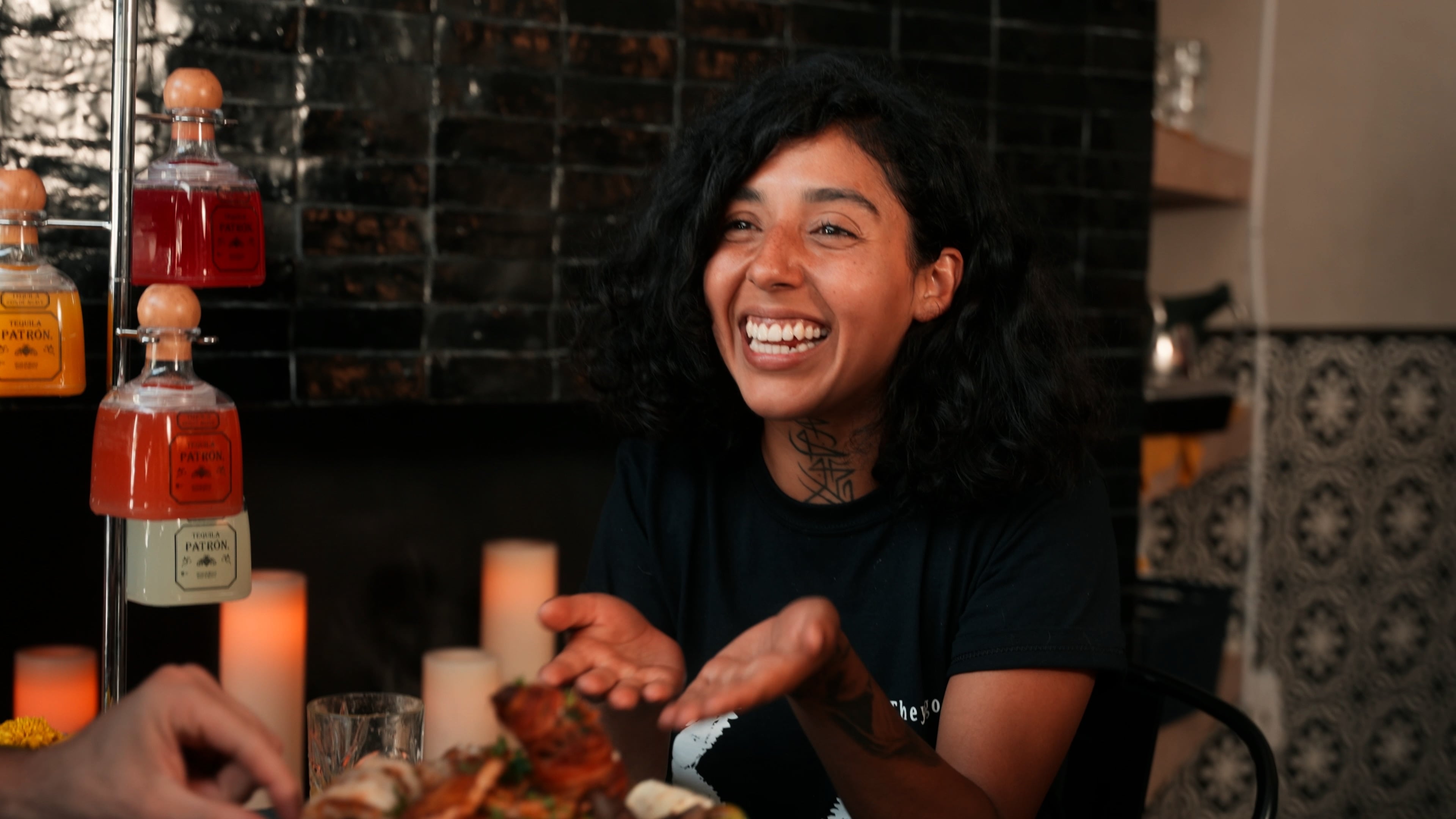 Diner laughing at the table next to a tequila flight