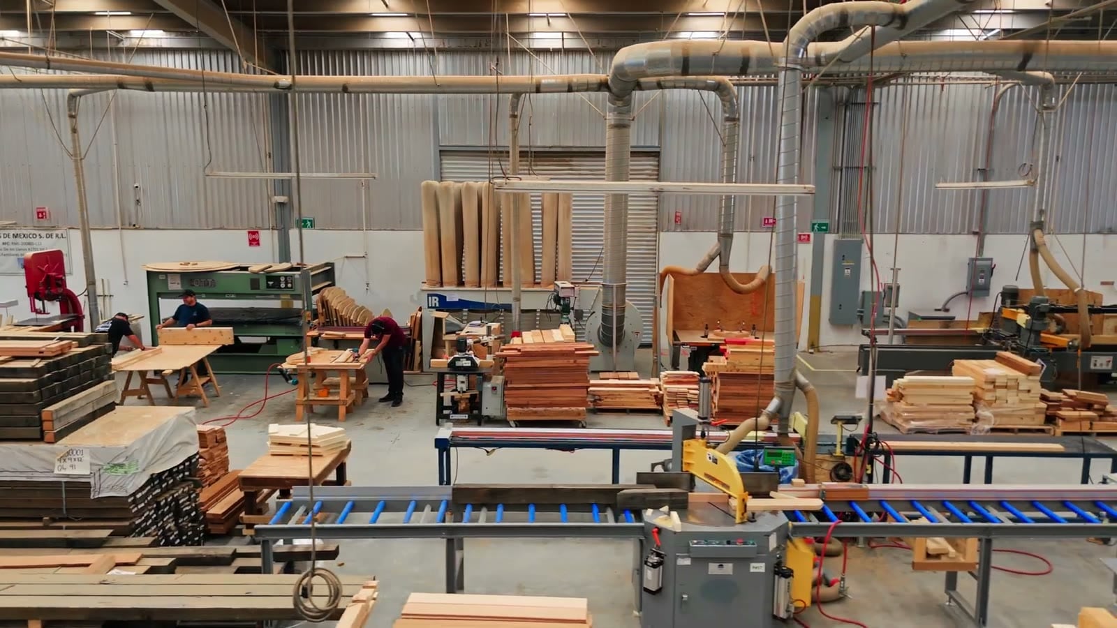 Wide view of the Roberts Hot Tubs factory floor with workers at benches and machines